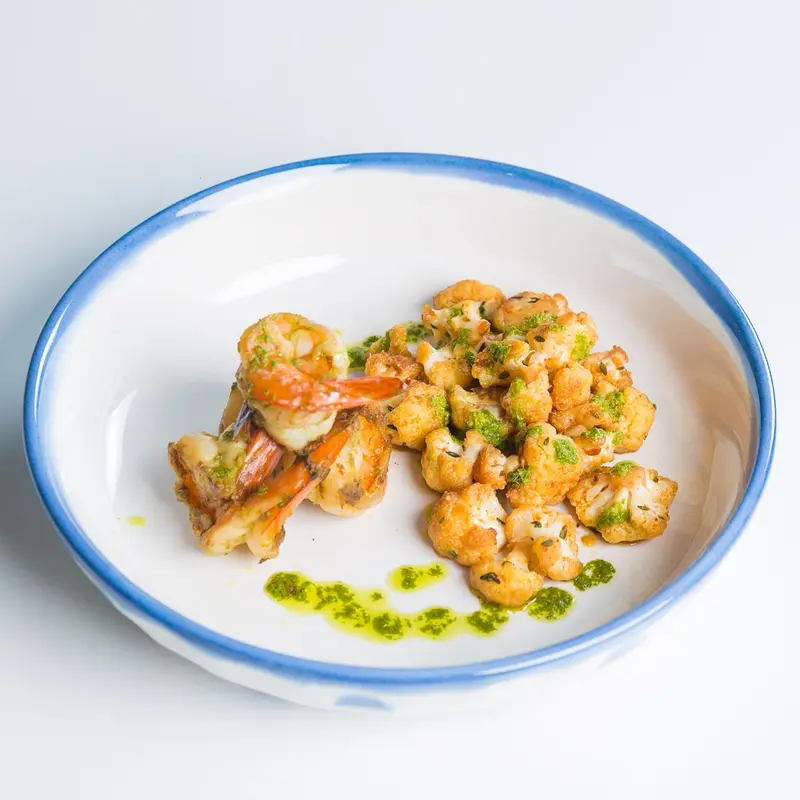 Pepper shrimp over roasted cauliflower with herb oil