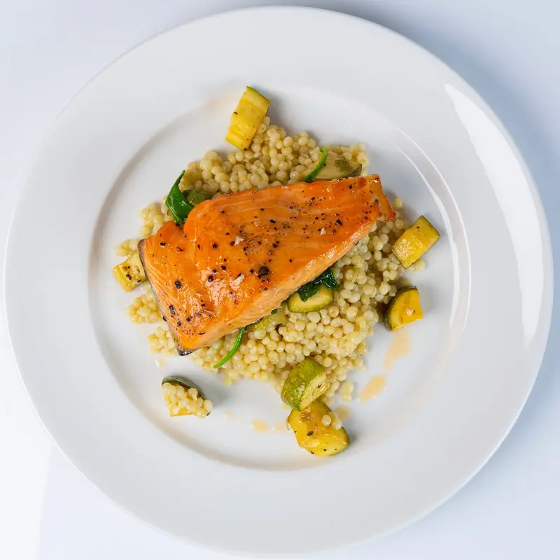 Pan-roasted salmon over pearl couscous with squash