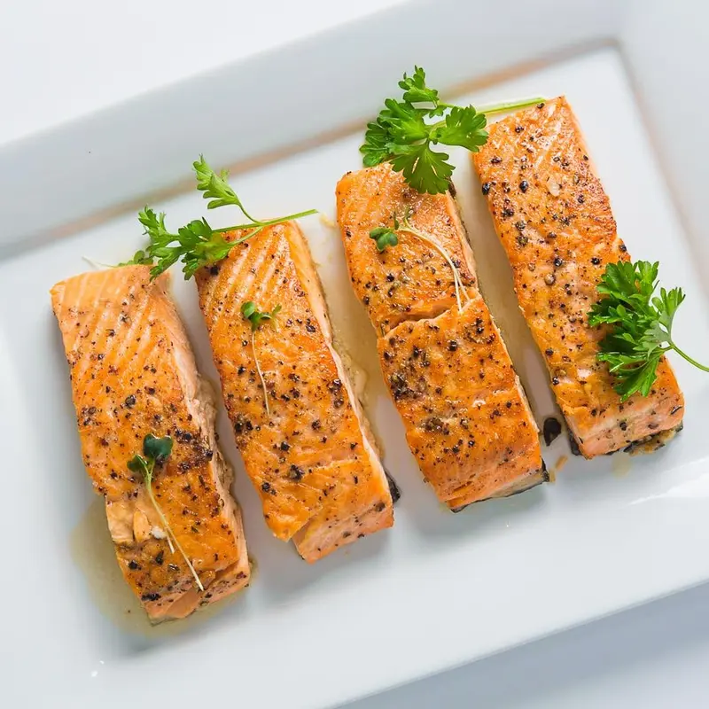 Pan-roasted salmon fillets on a platter