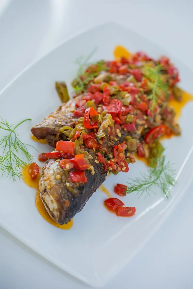 Roasted sea bass under a bright pepper and dill relish
