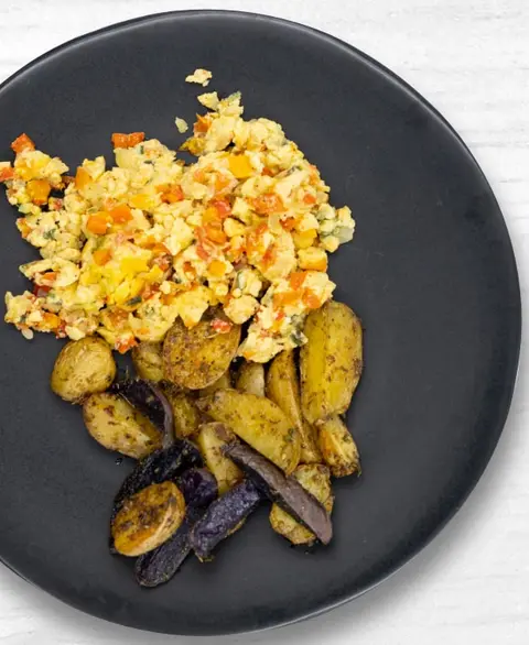 West African egg scramble with herb-roasted potatoes